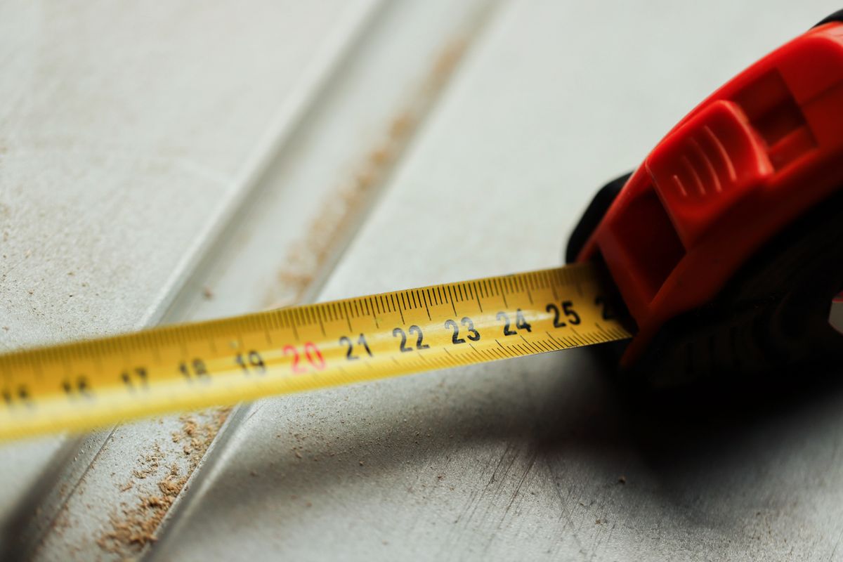 Close view of a tape measure resting against a building surface